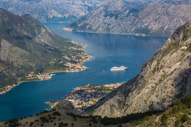 A cruise ships idles in the Bay of Kotor