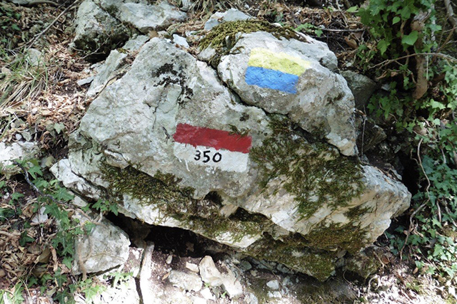 Some waymarkings on a rock on the St Francis Way on the walk from Assisi to Spello. CC BY Tony Lewis / flickr